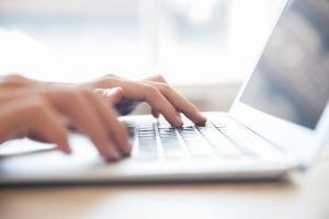 hands-typing-laptop-keyboard-ecms
